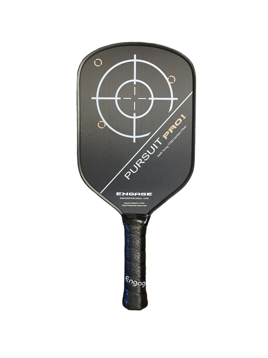 A black Engage Pursuit Pro1 Power Series Pickleball Paddle with a circular target design in the center and the text "Pursuit PRO 1" and "Engage" on the front, held vertically against a white background.