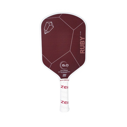 A red pickleball paddle with a white handle, labeled "Six Zero Ruby Kevlar (16mm) Pickleball Paddle" and "6.0", featuring geometric patterns and a logo from Six Zero.