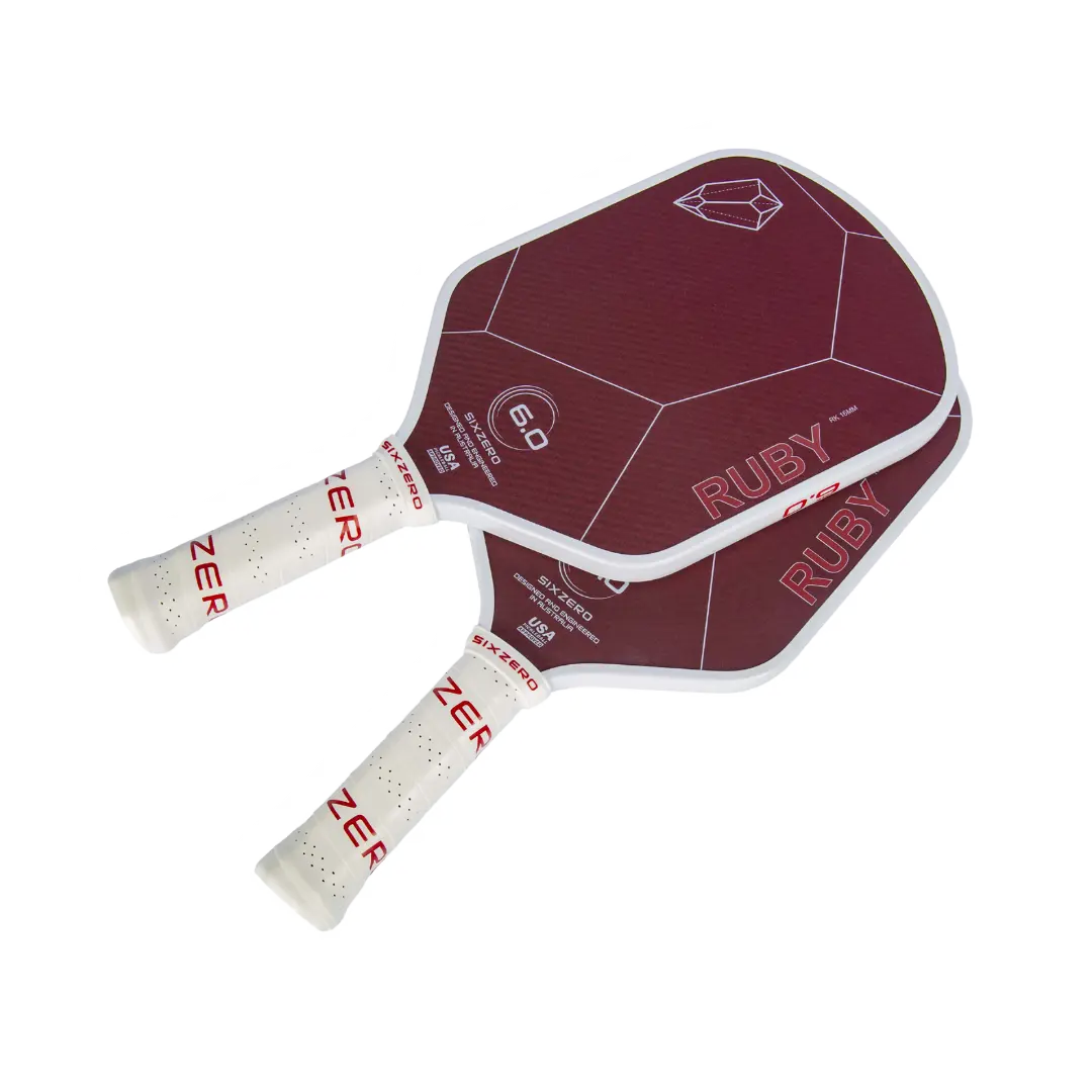 Two red and white pickleball paddles with "Six Zero Ruby Kevlar (16mm) Pickleball Paddle" and geometric designs on the faces, and the brand name "Six Zero" on the handles.