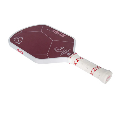 A Six Zero Ruby Kevlar (16mm) Pickleball Paddle for paddle sports with a maroon face, white frame, and white grip. The paddle has minimal text and graphics, including the brand name "Six Zero" and model "6.0".