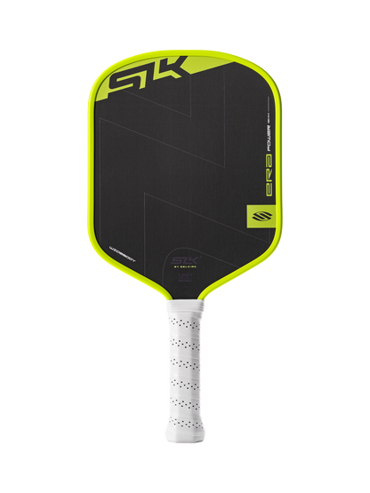 The Selkirk SLK ERA Power Widebody Carbon Fiber Pickleball Paddle, in black and yellow with a white perforated handle, features STK branding and raw spin technology for superior control.