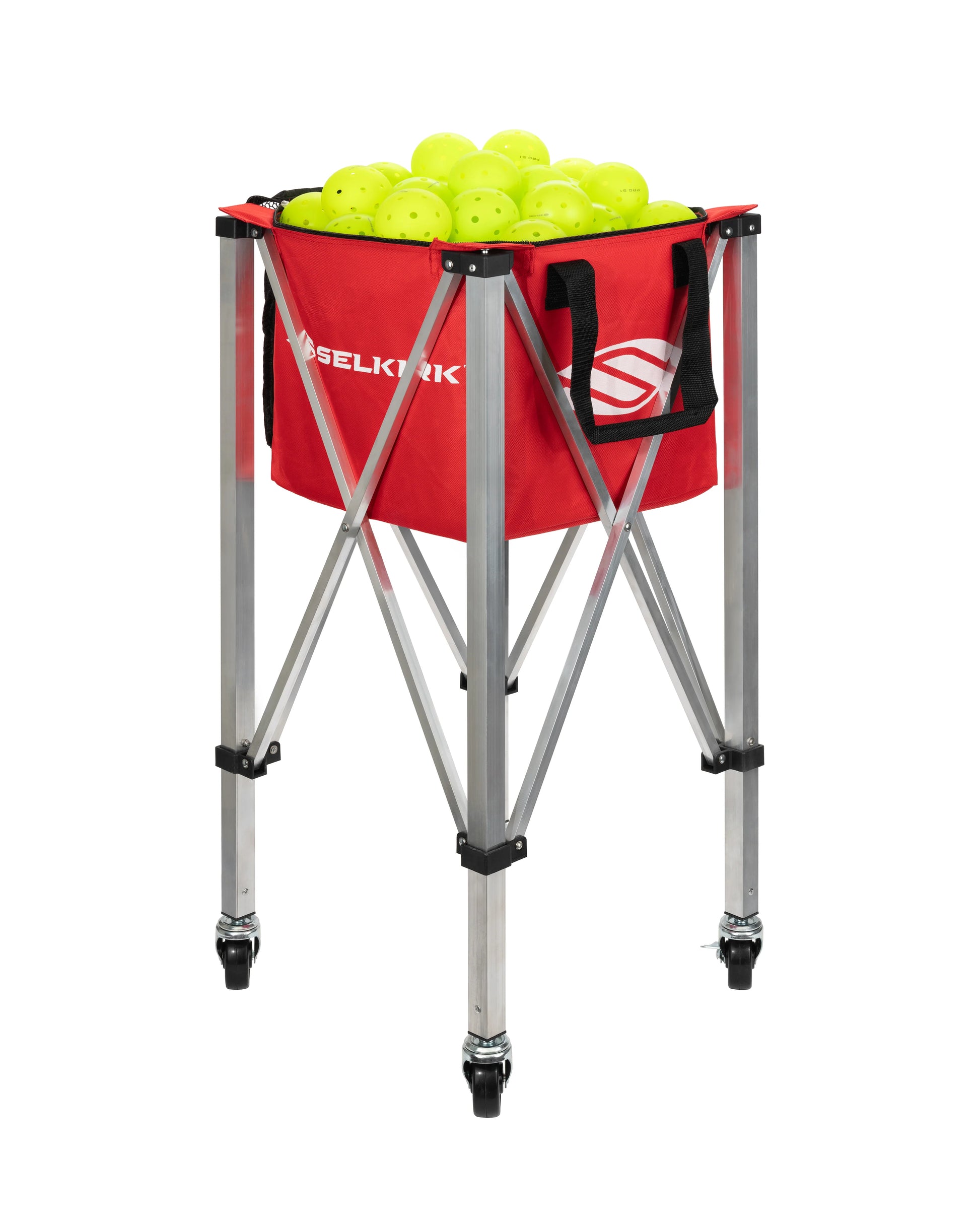 The Selkirk Pickleball Ball Carrier, a red, foldable nylon holder with wheeled metal legs, is filled with neon yellow balls specifically designed for sports use.