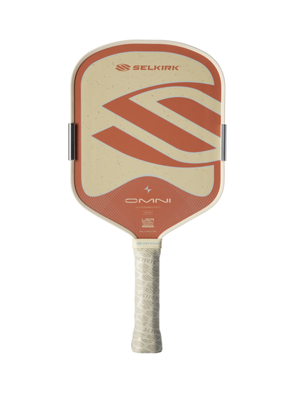 The Selkirk OMNI Widebody 16mm Pickleball Paddle features a beige and orange design, textured grip, and Selkirk logo—perfect for versatile all-court play.