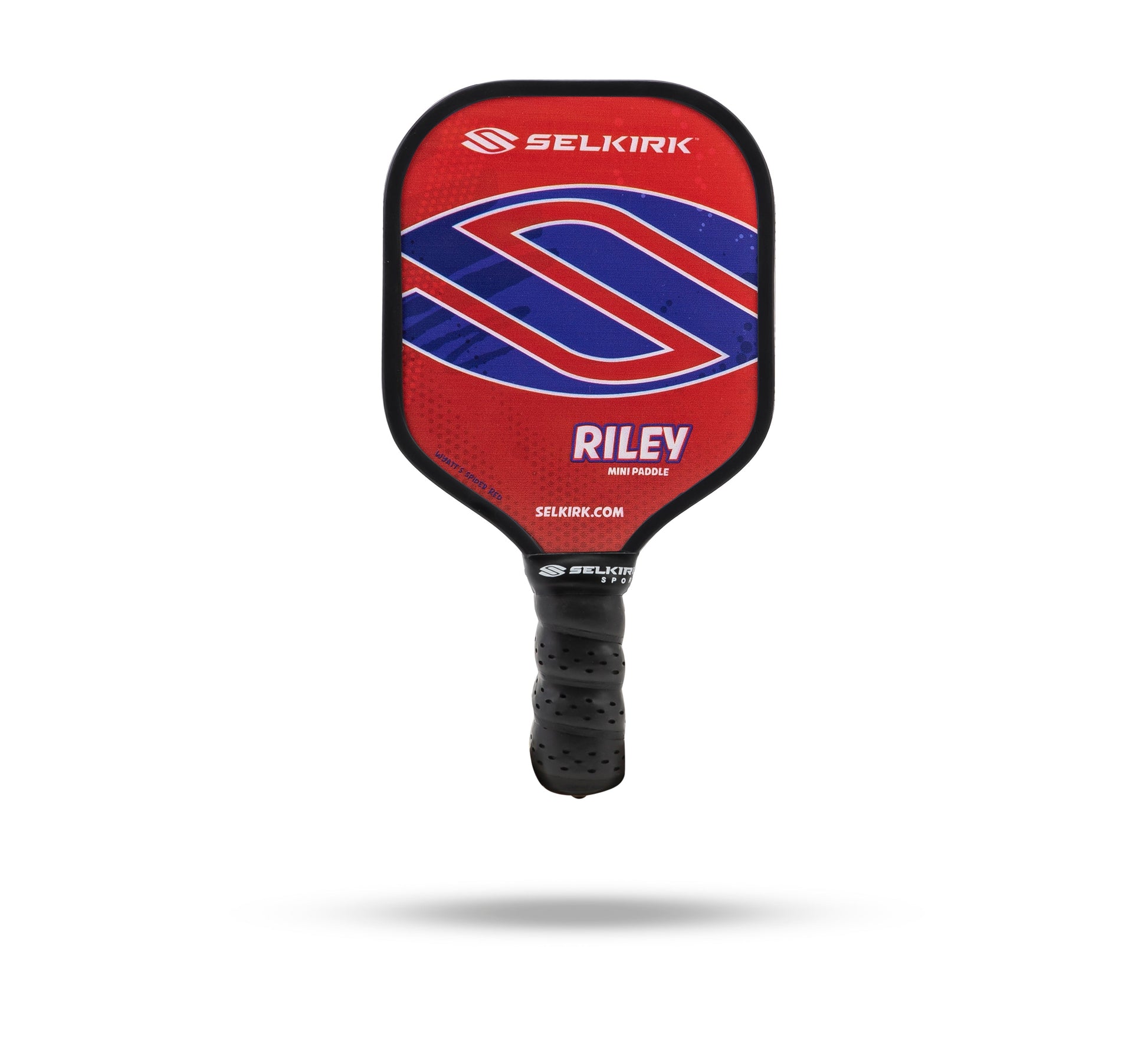 Introducing the Selkirk Riley Mini Pickleball Paddle Collection, featuring a paddle with a vibrant red, blue and white design. This novelty gift offers a fresh look that is sure to impress.