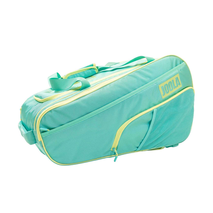 The Pickleballist 2026 Tour Elite Pro Pickleball Bag in turquoise and yellow features a front zip pocket, mesh side pocket, and top handles—ideal for tournament players, displayed against a white backdrop.
