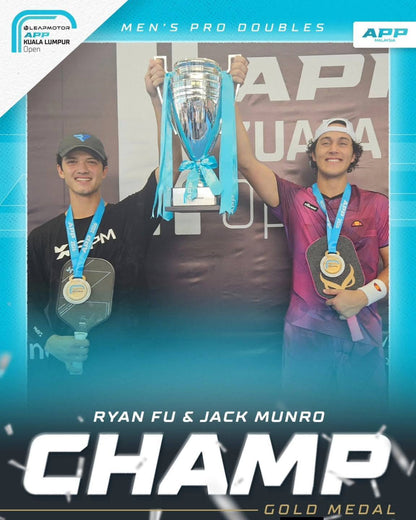 Two male athletes holding the OWL CXE - Drew Brees Limited Edition Quiet Pickleball Paddle and a trophy, wearing medals, stand under a "Men's Pro Doubles" banner. Text at the bottom reads "Ryan Fu & Jack Munro CHAMP Gold Medal.