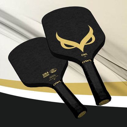 Two OWL CXE - Drew Brees Limited Edition Quiet Pickleball Paddles in black with gold owl logos and OWL-branded handles are shown on a white, black, and gold background, crafted from advanced Propylux Acoustene composite for premium performance.