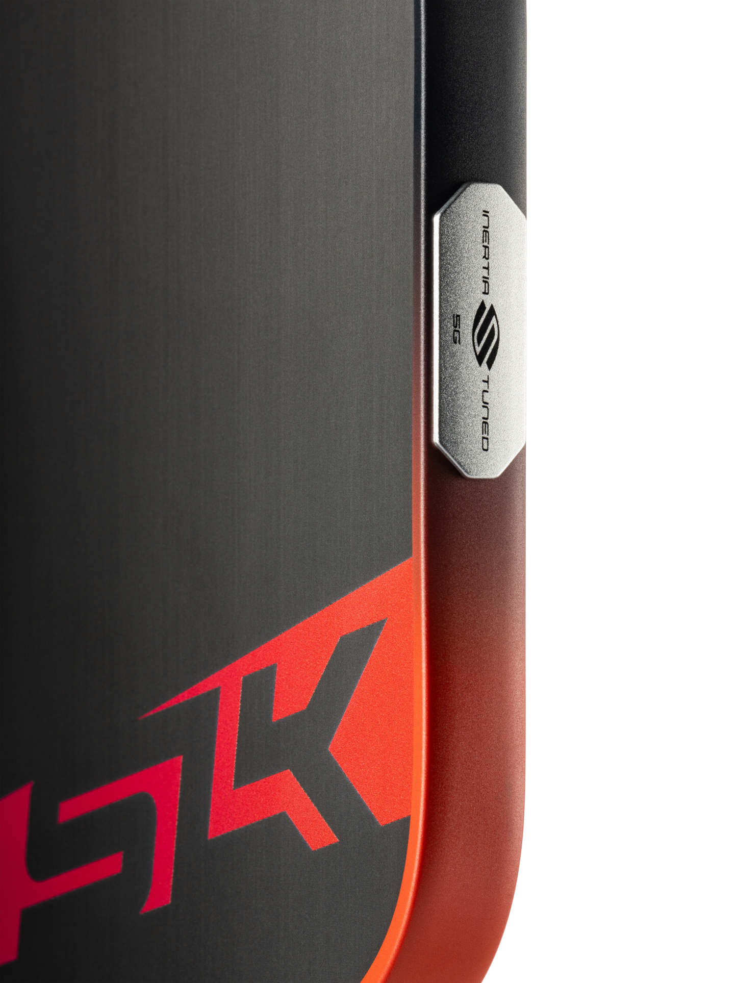 Close-up of a ski features a black and red design with "HK" and a metal plate marked "INERTIA S TURBO ESS," recalling the bold graphics on the Selkirk SLK Dauntless Elongated 16mm Pickleball Paddle by Selkirk.