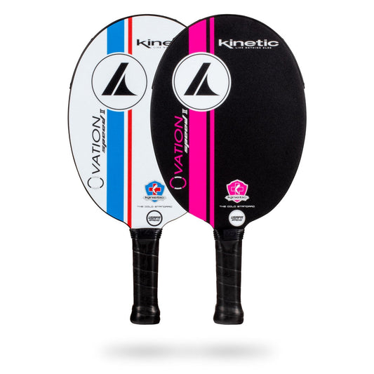 Two ProKennex Kinetic Ovation Speed II Pickleball Paddles with black handles and Spin-Grab outer layers. One paddle has a white and blue design, while the other sports a black and pink design. Both feature the brand name "ProKennex," "Kinetic Ovation Speed II," and boast Opti-Cell Core construction for optimal performance.