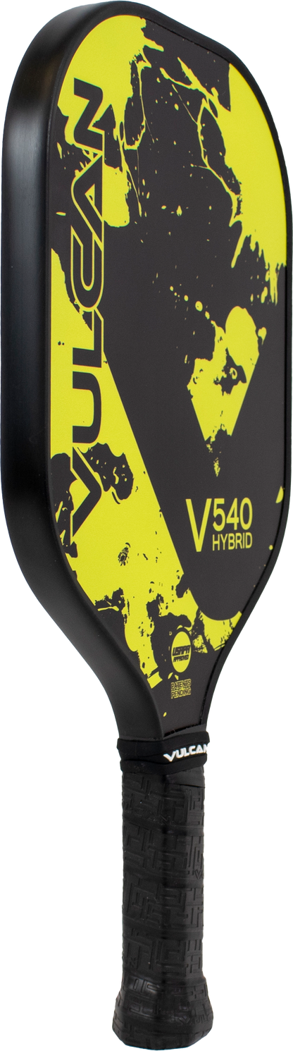 A Pickleballist Vulcan V540 hybrid pickleball paddle with a black and yellow splatter design and textured grip.