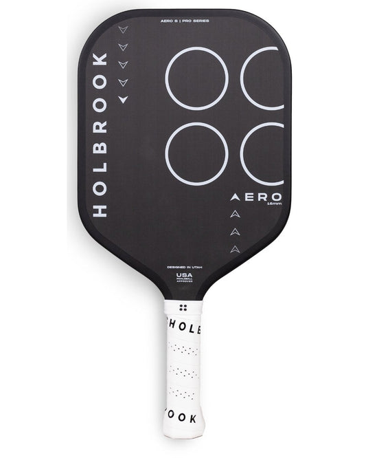 The Holbrook Pro - Aero S 16 mm Pickleball Paddle features a black design with "HOLBROOK" on the left side and "AERO" on the right. It has white circles on the upper half and a white handle adorned with black text.