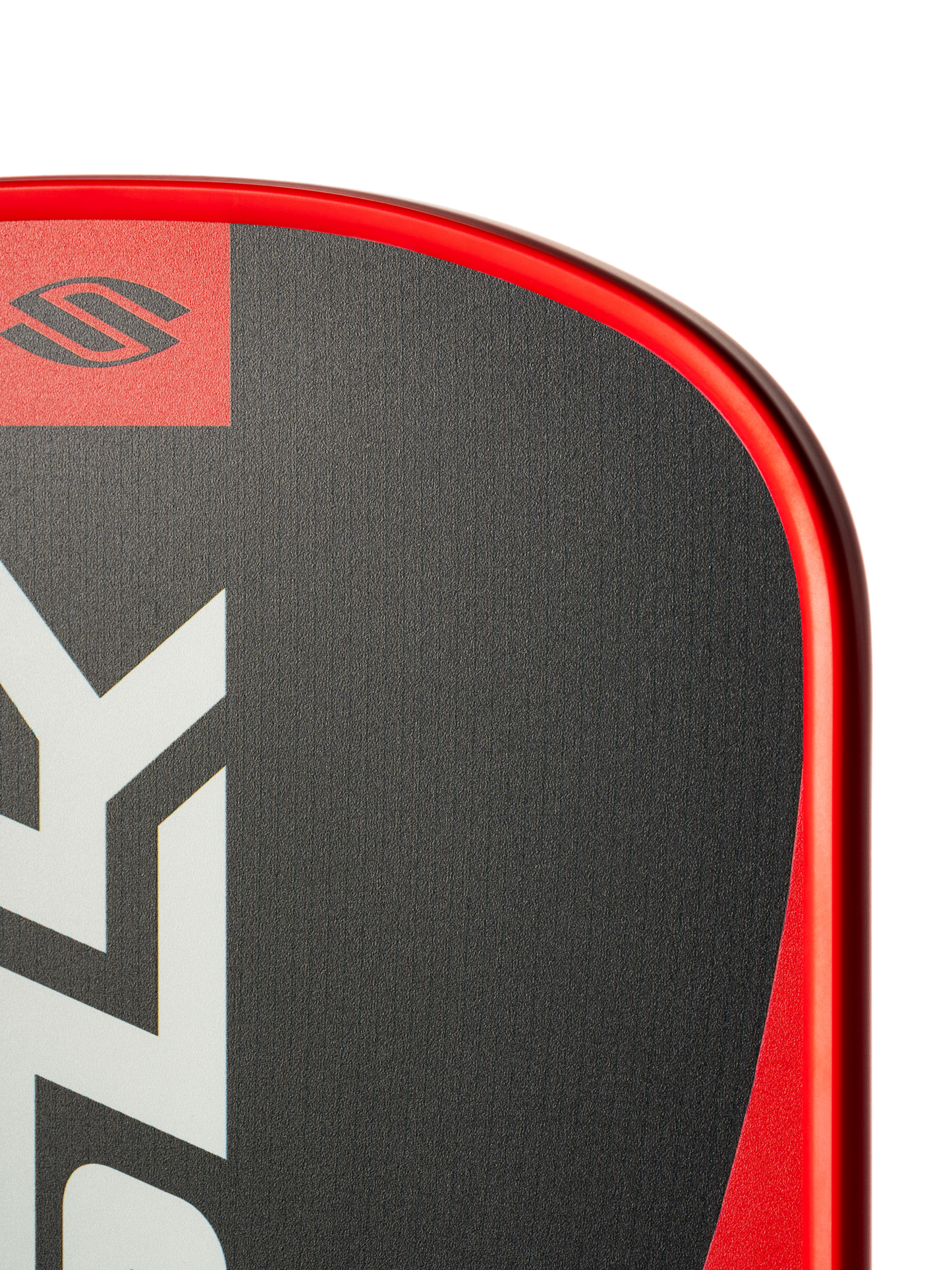 Close-up of the top corner of a Selkirk SLK Valkyrie Widebody 16mm Pickleball Paddle, featuring a red edge, black and gray surface, and partial Selkirk logo.