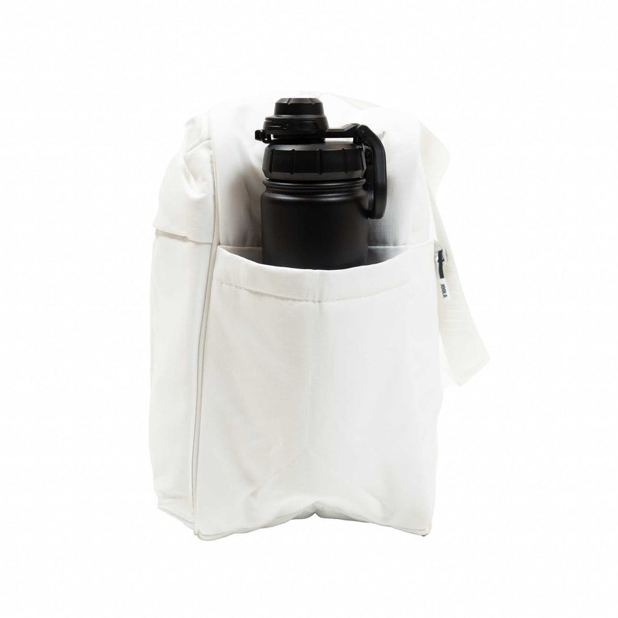 The JOOLA Overnighter Puff Bag, a white fabric pickleball bag by JOOLA, features durable construction and an external pocket holding a black water bottle, shown against a plain white background.