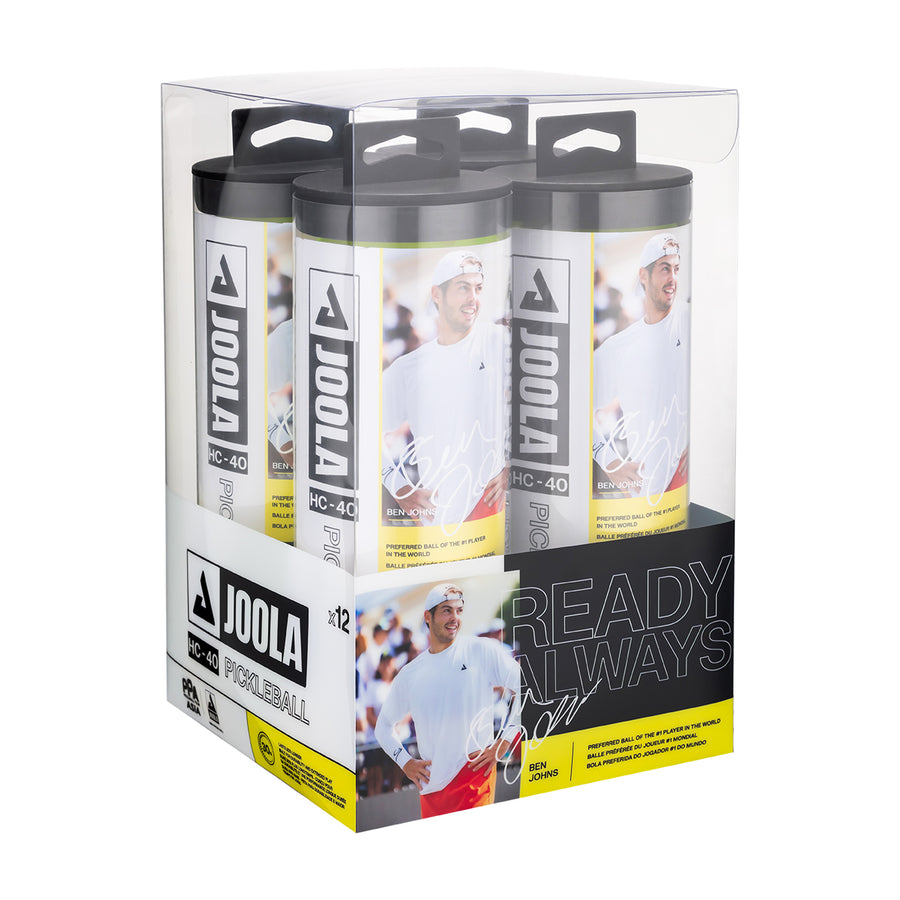 A clear box contains twelve Pickleballist JOOLA HC-40 Pickleballs - Shock Yellow, with branding, product details, and a smiling athlete image displayed on the packaging.