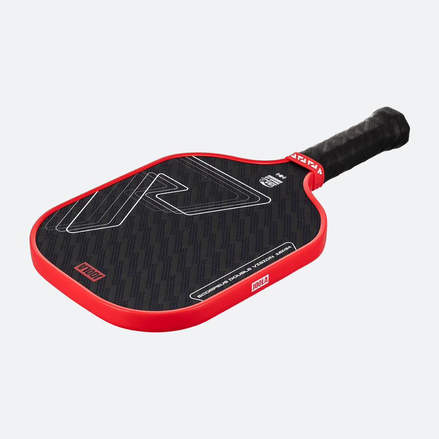 The JOOLA Double Vision Scorpeus 16mm Pickleball Paddle, in black with a red edge and handle, sports a geometric face design. Shown on a light gray background, it's an ideal choice for advanced players.