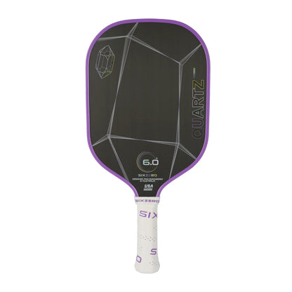 A black Six Zero pickleball paddle with geometric designs, a purple border, "Six Zero Quartz 6.0" branding, and a white handle.