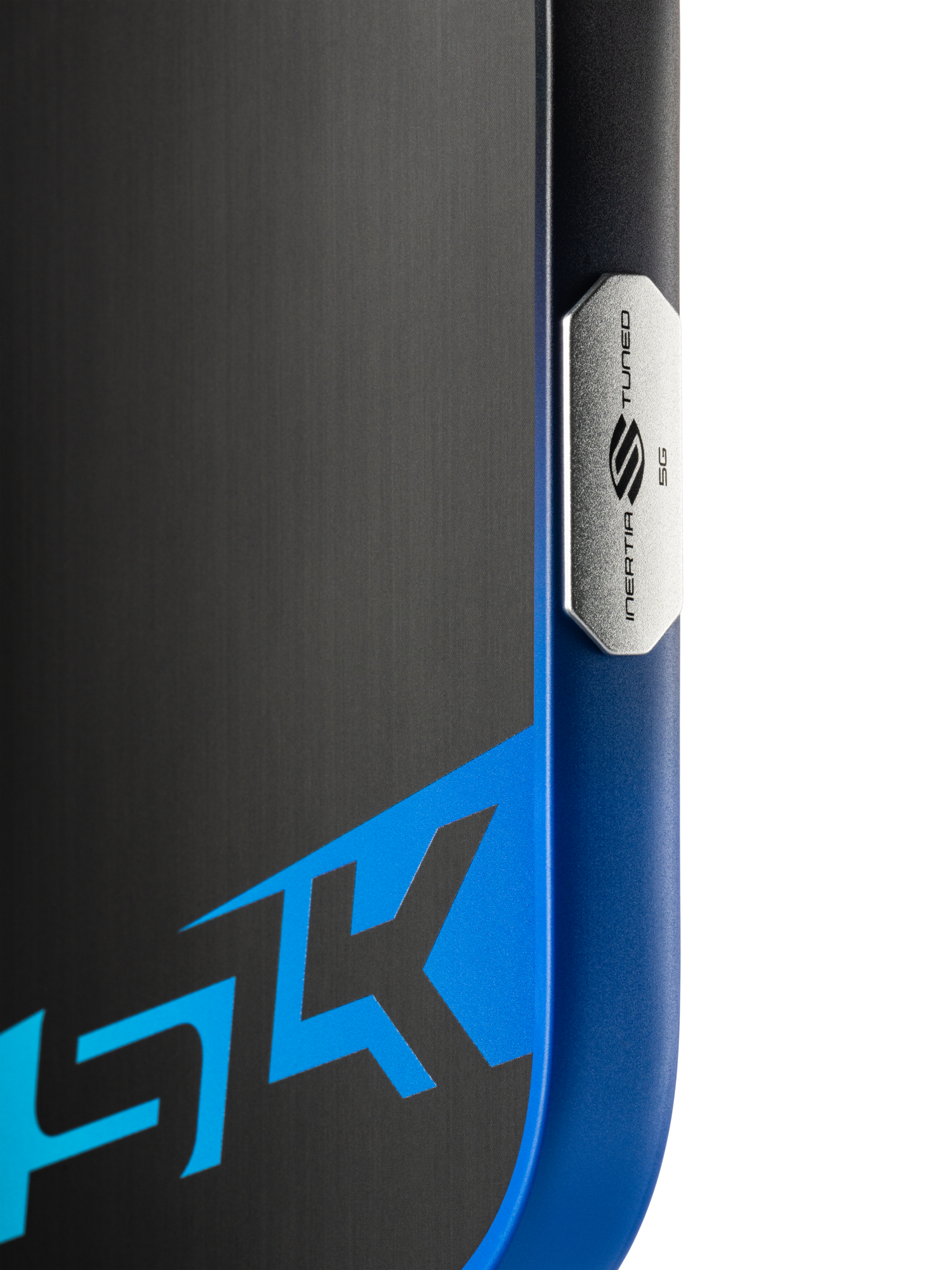 Close-up of a Selkirk SLK Dauntless Elongated 16mm Pickleball Paddle, featuring a metallic "Media Tuned 5G" badge and partial blue-black design with "5K," echoing the paddle’s modern Selkirk style.