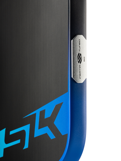 Close-up of a Selkirk SLK Dauntless Elongated 16mm Pickleball Paddle, featuring a metallic "Media Tuned 5G" badge and partial blue-black design with "5K," echoing the paddle’s modern Selkirk style.