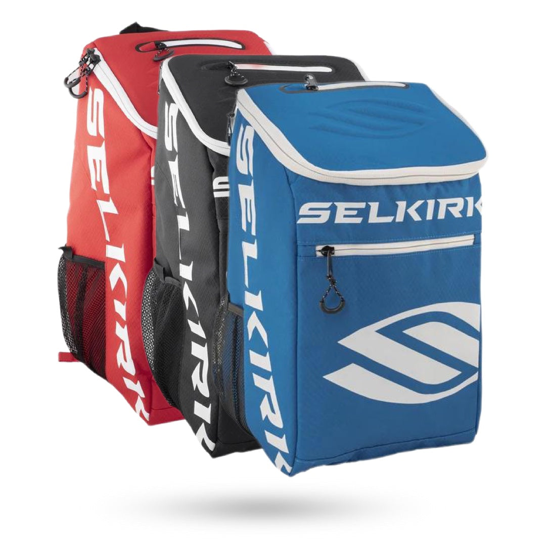 Two Pickleballist-branded Selkirk Team Backpack (2021) pickleball bags, one blue and one red, crafted from V9 Polyfiber Performance Material and designed to carry paddles and gear, displayed against a white background.