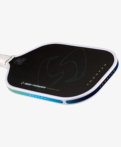 A close-up of the Gearbox Sports GBX Power Elongated - 16mm Gen-3 Honeycomb pickleball paddle, featuring a black carbon fiber face, white edge, blue-green accents, and the Gearbox logo and text on its surface.