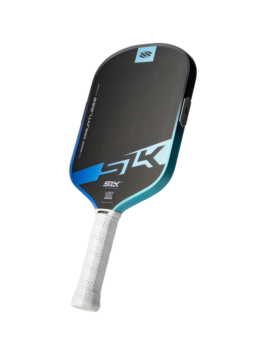 The Selkirk SLK Dauntless Elongated 16mm Pickleball Paddle features a black and blue face, white grip, and "DAUNTLESS" branding; designed by Selkirk for enhanced control and power.