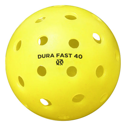 A yellow pickleball with the text "Onix Dura Fast 40 Pickleball Balls" printed on it, featuring multiple circular holes.