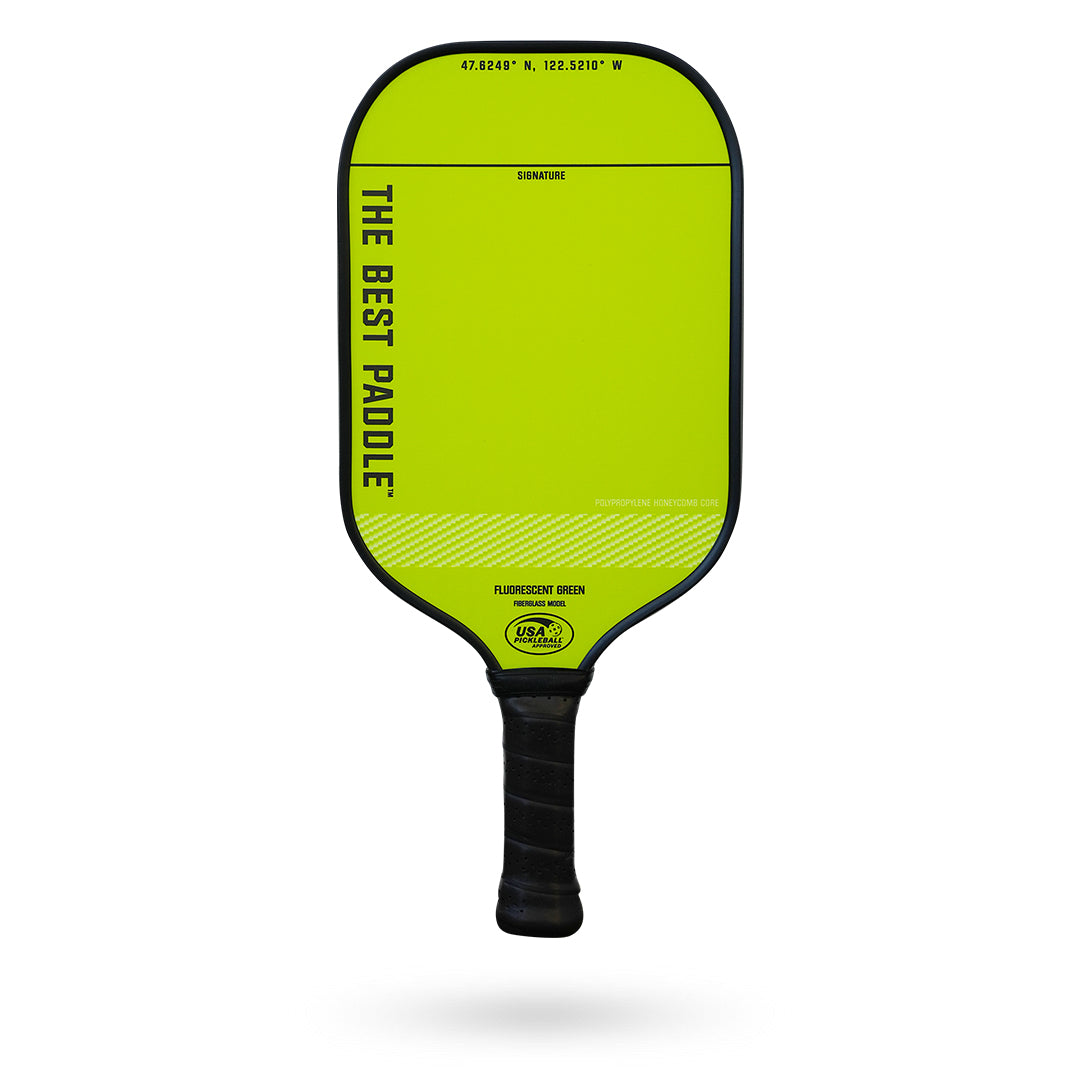 A yellow paddle with The Best Paddle Fiberglass Pickleball Paddle on it.