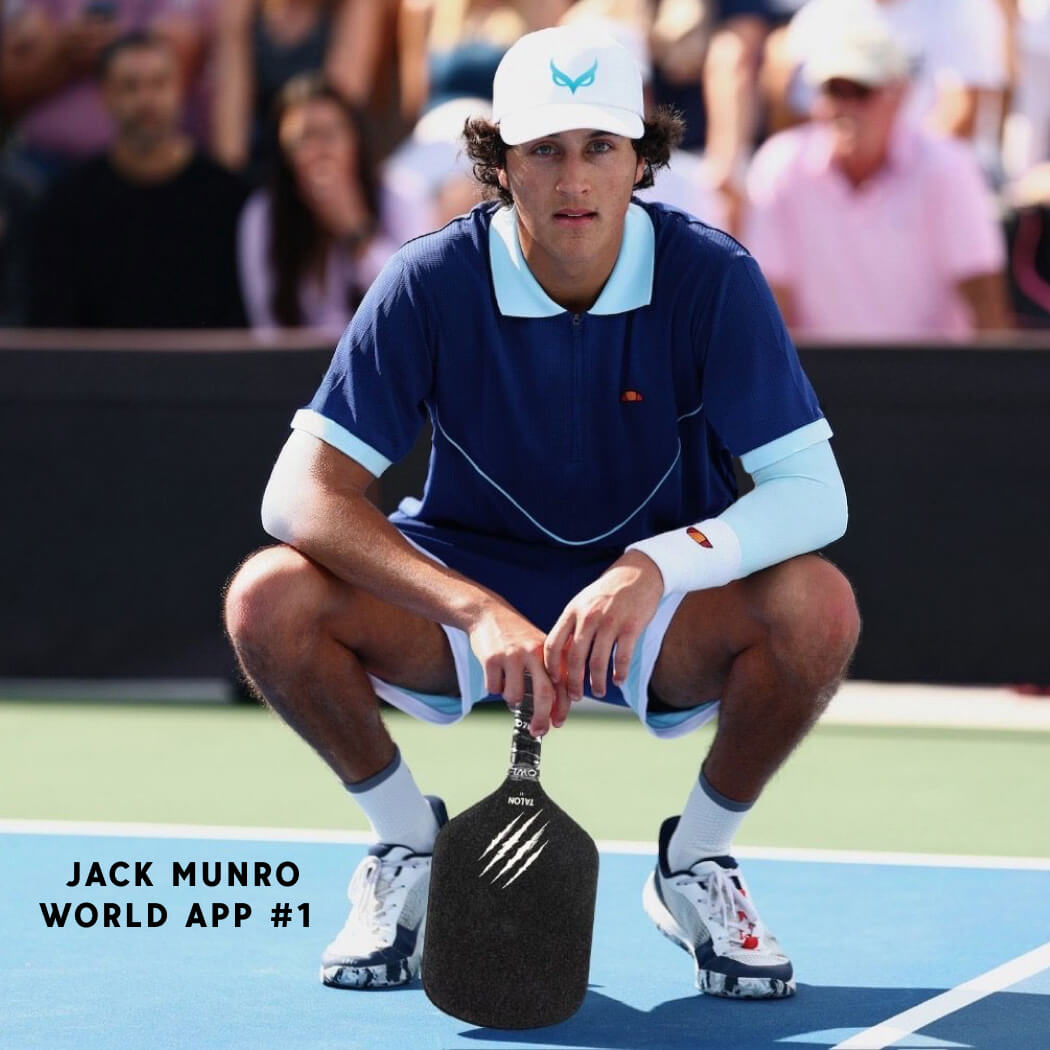 A male athlete in tennis attire squats on a court holding an OWL Talon X1 Quiet Pickleball Paddle, highlighting its superior spin control. The image displays the text: "JACK MUNRO WORLD APP #1," with spectators watching in the background.
