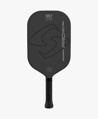 The Gearbox Pro Control Elongated Pickleball Paddle features a black design with "SST Core" text and logo. It has a textured handle, crafted with advanced Solid Span Technology and a carbon fiber framework for optimal performance.