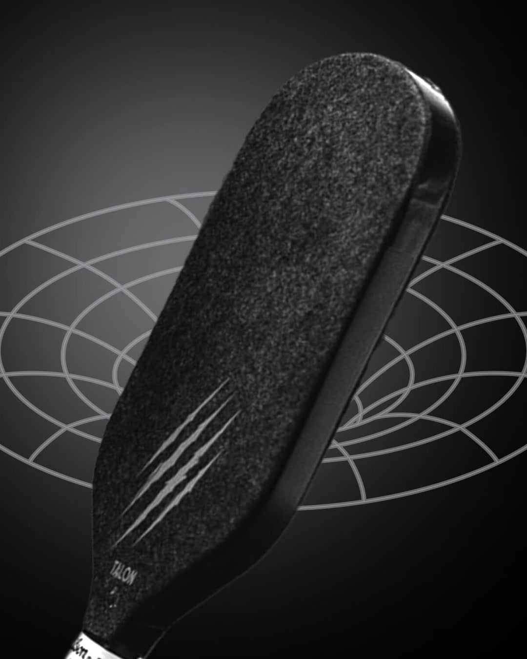 A close-up of the OWL Talon X1 Quiet Pickleball Paddle by OWL, featuring claw-like scratch marks for enhanced spin control, set against a dark background with a geometric circular pattern.
