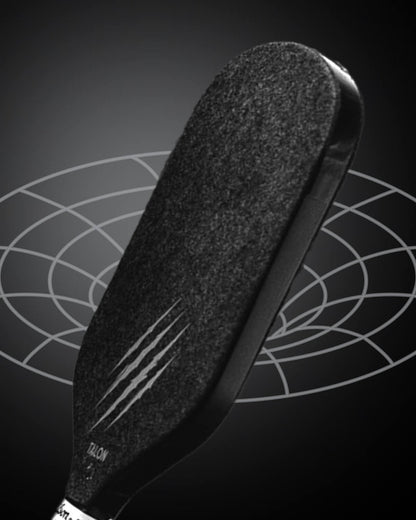 A close-up of the OWL Talon X1 Quiet Pickleball Paddle by OWL, featuring claw-like scratch marks for enhanced spin control, set against a dark background with a geometric circular pattern.