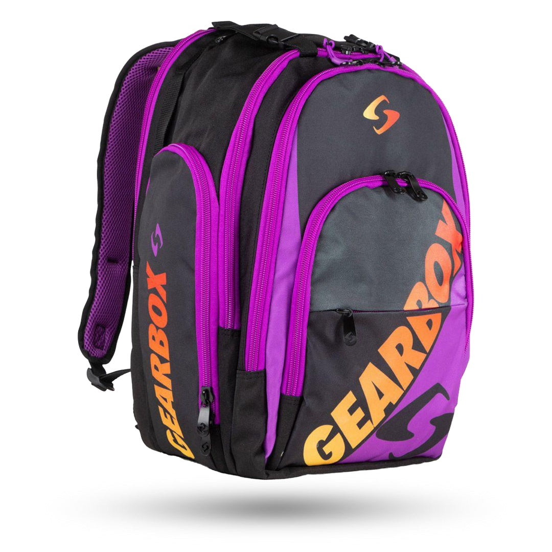 A black and purple full-sized backpack with "GEARBOX" written in yellow and red on the front pocket. It boasts spacious compartments, multiple zippered pockets, and a padded back, making it durable and practical for everyday use. The Gearbox Court Backpack Pickleball Bag by Gearbox is perfect for carrying all your essentials.