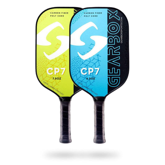 Two Gearbox CP7 Pickleball Paddles with "Gearbox CP7" and "Gearbox" branding. One paddle is yellow, the other blue, featuring a carbon fiber face and poly core construction. Weighing 7.8oz and 8.5oz respectively, these Gearbox CP7 Pickleball Paddles offer optimal performance for avid players.