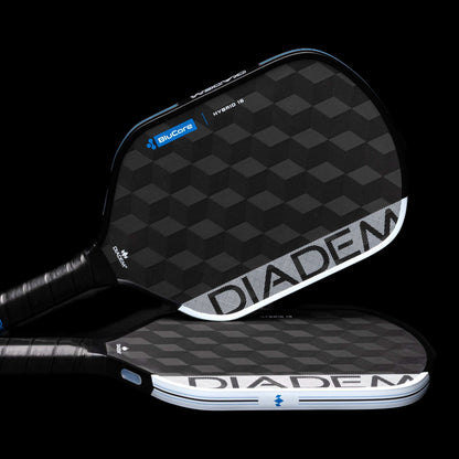 Two Diadem Edge BluCore Hybrid 16mm Pickleball Paddles with textured geometric patterns, white branding, and blue accents are displayed diagonally on a sleek black background.