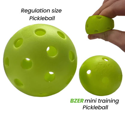 Image shows a standard yellow pickleball beside a smaller yellow BZER Mini Training Pickleball by Bzer Sports, ideal for training and hand-eye coordination, with one ball being held in hand.