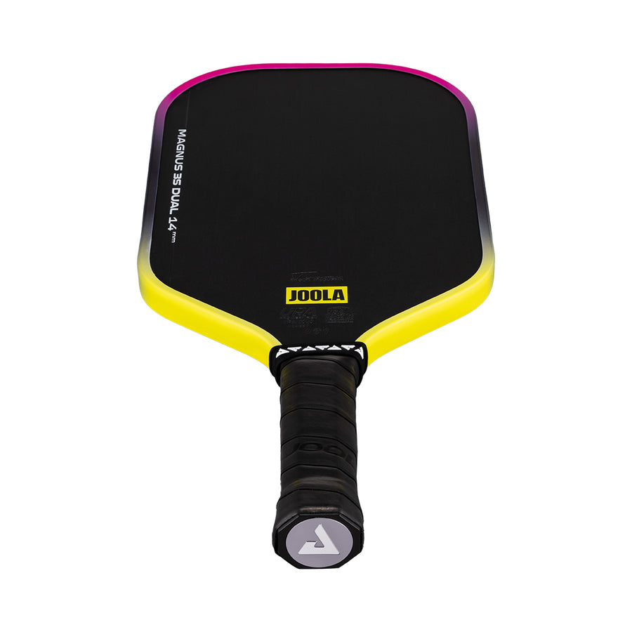 The JOOLA Magnus 3S Dual 14mm Pickleball Paddle is black with yellow and pink edges, a black grip handle, visible JOOLA logo, and features a Charged Carbon Surface for added spin and durability.