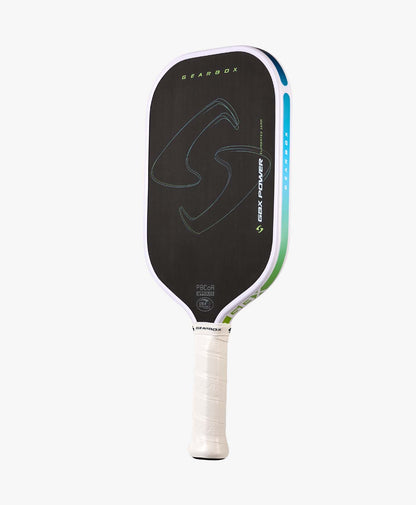 The Gearbox Sports GBX Power Elongated - 16mm Gen-3 Honeycomb paddle features a black carbon fiber face with green and blue accents, a white handle, extended reach design, and branding on the face and edge.
