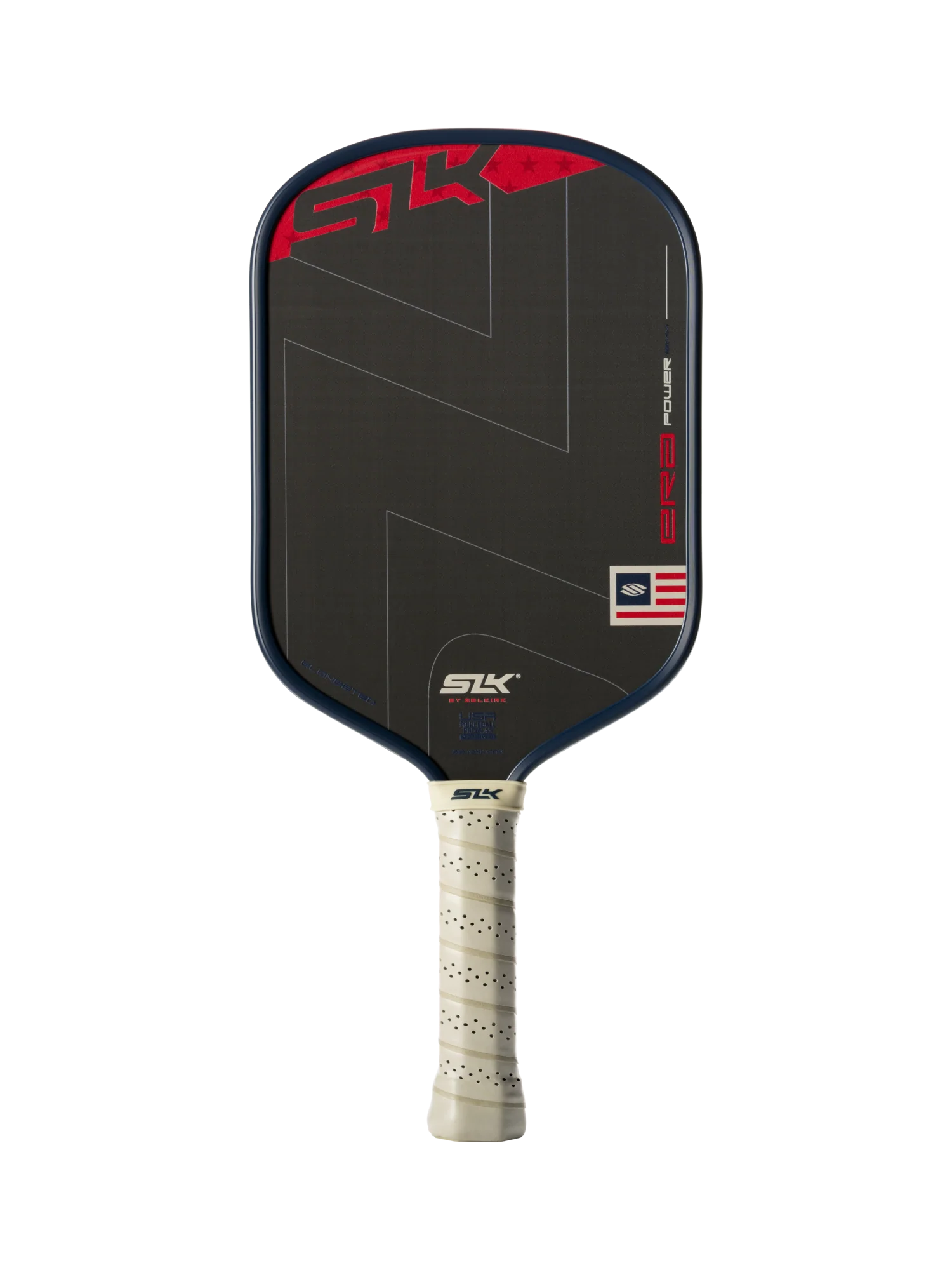 The Selkirk SLK ERA Power Elongated Carbon Fiber Pickleball Paddle by Selkirk features a sleek black elongated design, a beige perforated grip, red and white graphic accents, and a small American flag detail on the lower right corner of the paddle face.