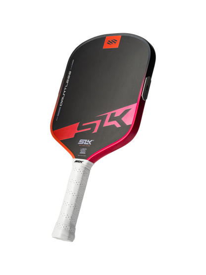 The Selkirk SLK Dauntless Widebody 16mm Pickleball Paddle features a black and red design, a white grip, and displays the Selkirk logo and name "SK" on the face and handle.