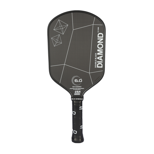 A Six Zero Double Black Diamond Elongated (DBDe) 15mm Pickleball Paddle with the label "Double Black Diamond" on its face. The handle features a grip with white lettering, and the paddle surface showcases geometric designs and specifications.