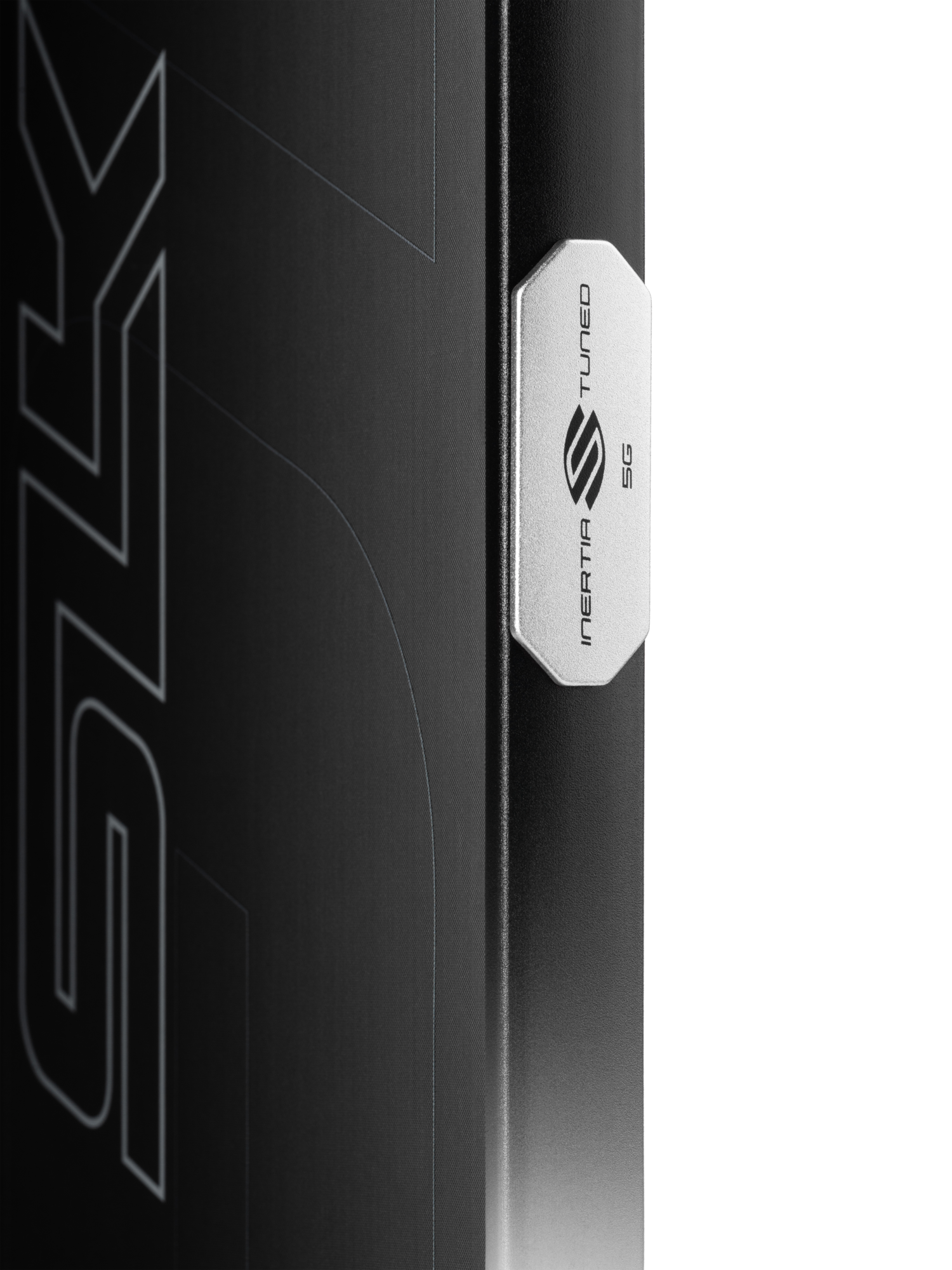 Close-up of a black Selkirk SLK GEO Widebody 14mm Pickleball Paddle with a metallic Selkirk badge, highlighting its 14mm thickness and signature widebody design elements in the background.